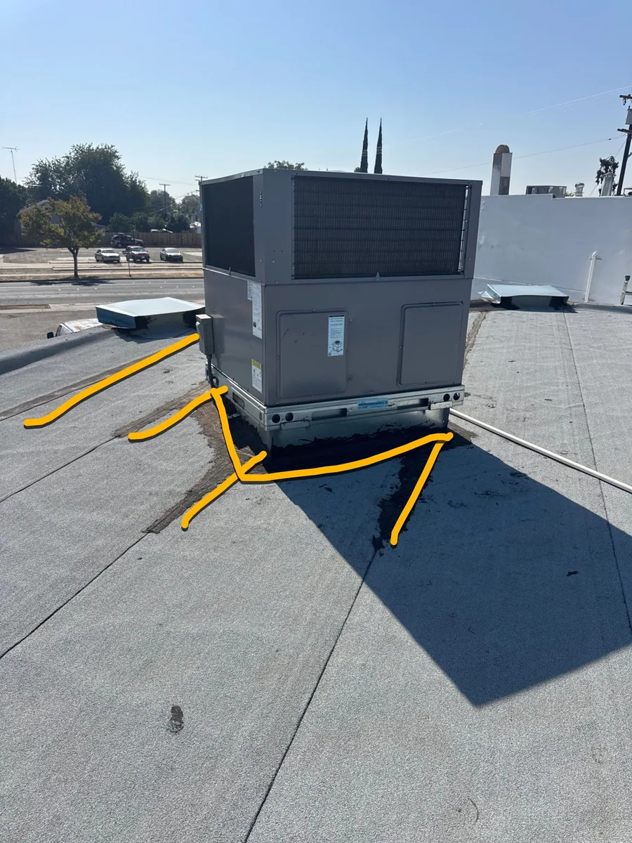 Leak paths marked in yellow around the rooftop HVAC unit during the Beto's Bakery roof inspection