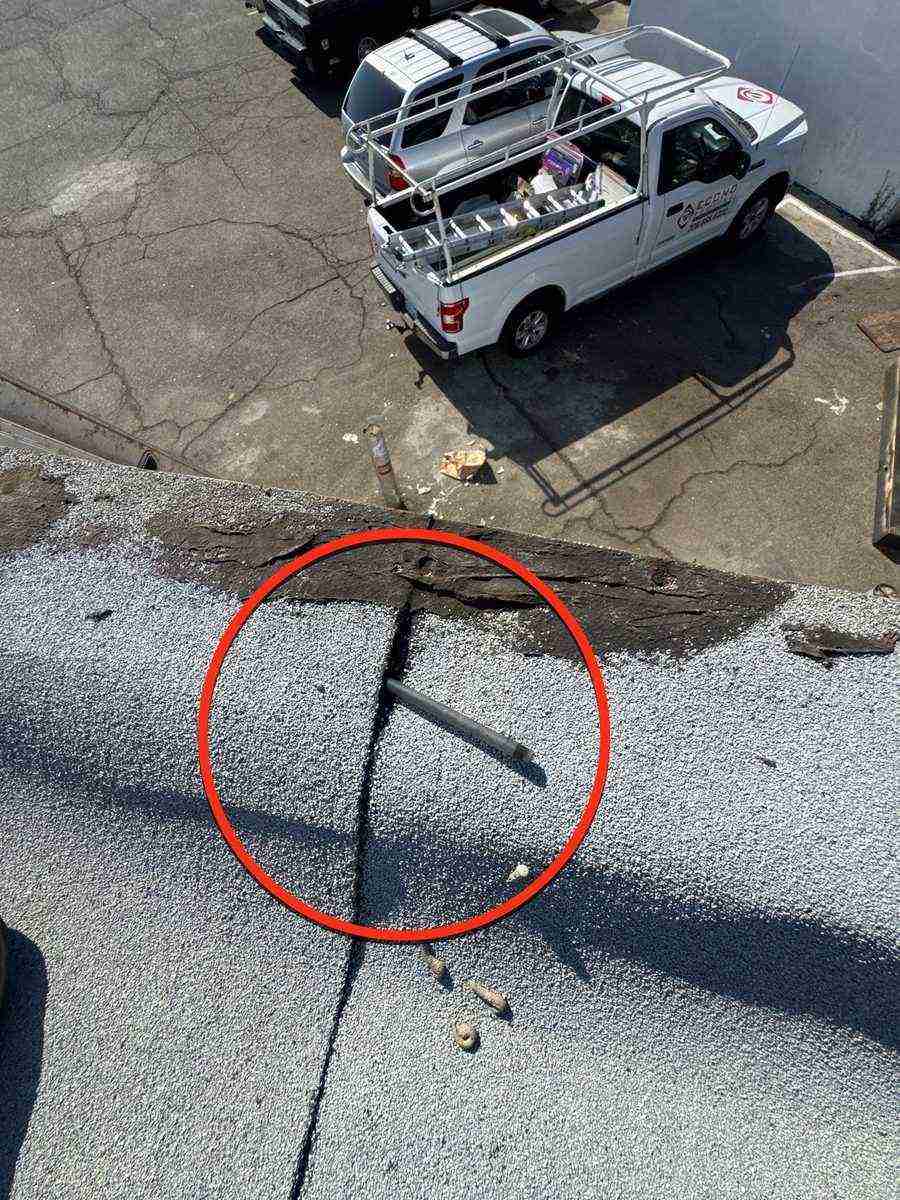 Roof inspection finding circled in red on a flat roof seam