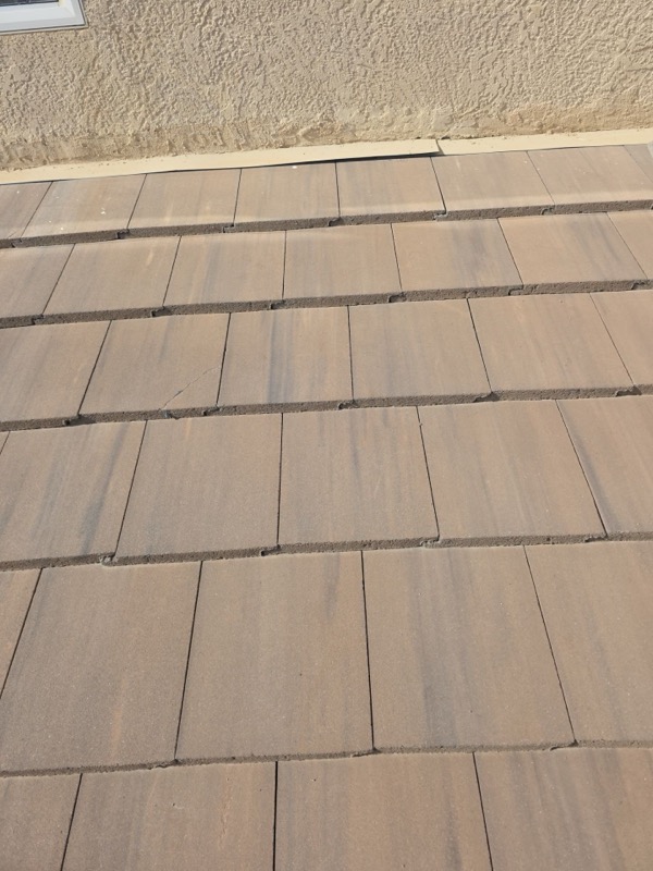 Damaged tiles at stucco wall junction showing failed flashing