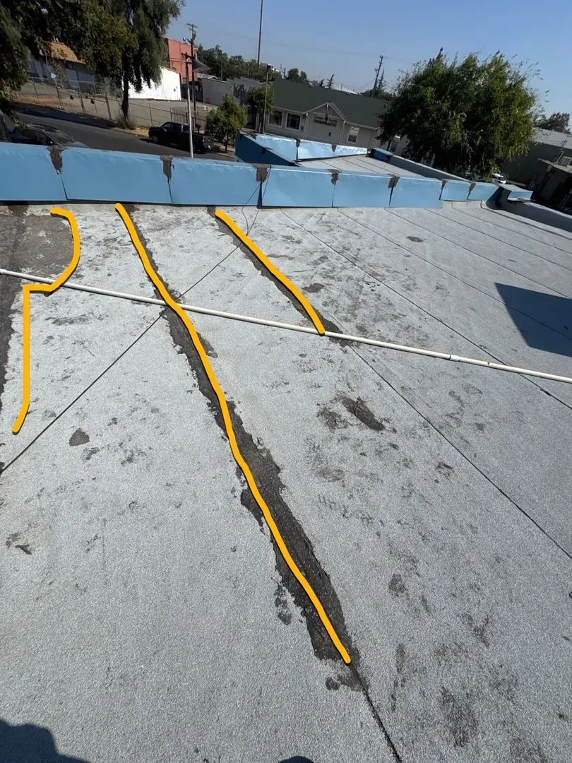Beto&rsquo;s Bakery flat roof in Modesto before coating — aging, weathered membrane
