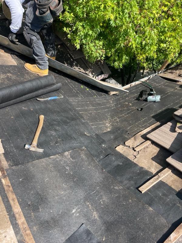 New underlayment being installed on roof deck