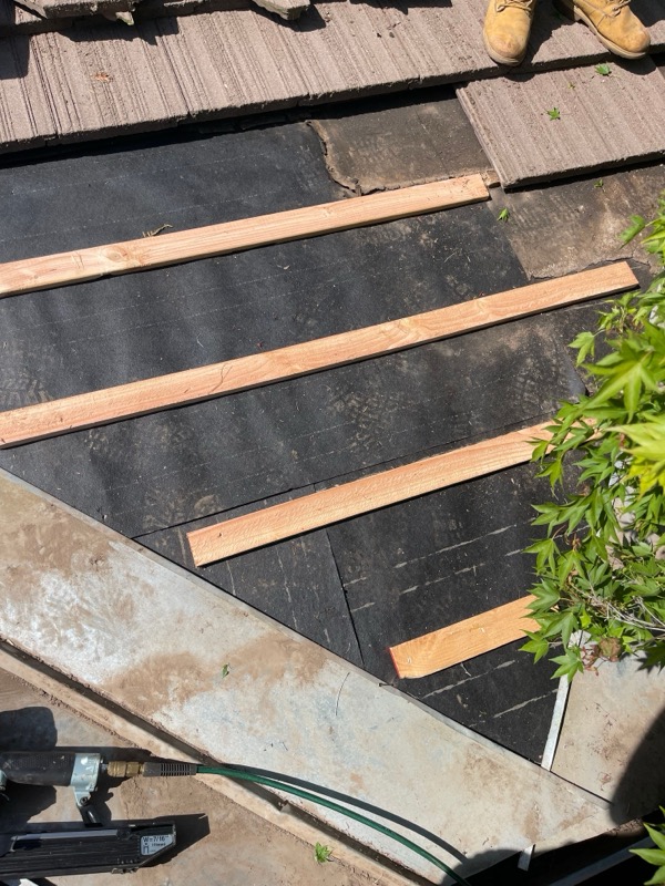 New wood battens installed over fresh underlayment