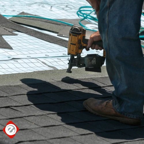 Econo Roofing crew member nailing shingles on a Central Valley residential roof
